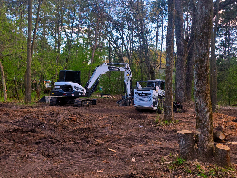 Heavy machinery clearing land for site preparation